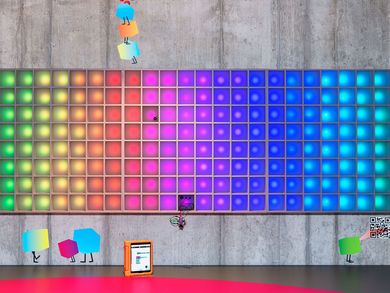 The pixel display wall is illuminated in rainbow colors.