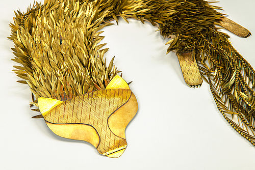 A fox stole made of brass. Hundreds of navette shaped earring stampings form the fur. 