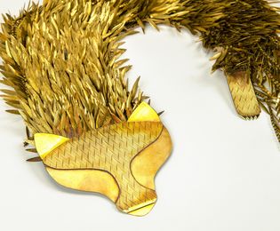 A fox stole made of brass. Hundreds of navette shaped earring stampings form the fur. 