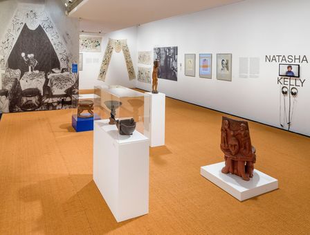 Blick in die Ausstellung im Brücke-Museum mit veschiedenen Skulpturen am Boden sowie einigen Zeichnungen und Gemälden an den Wänden.