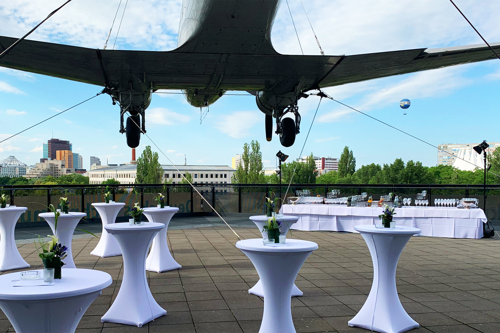The "Raisin Bomber" on the museum's terrace, set among festively decorated bar tables.