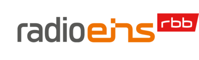 The logo for the radio station radio eins. The word "radio" is in gray, "eins" is in orange, and next to it, "rbb" is in white superscript on a red background.
