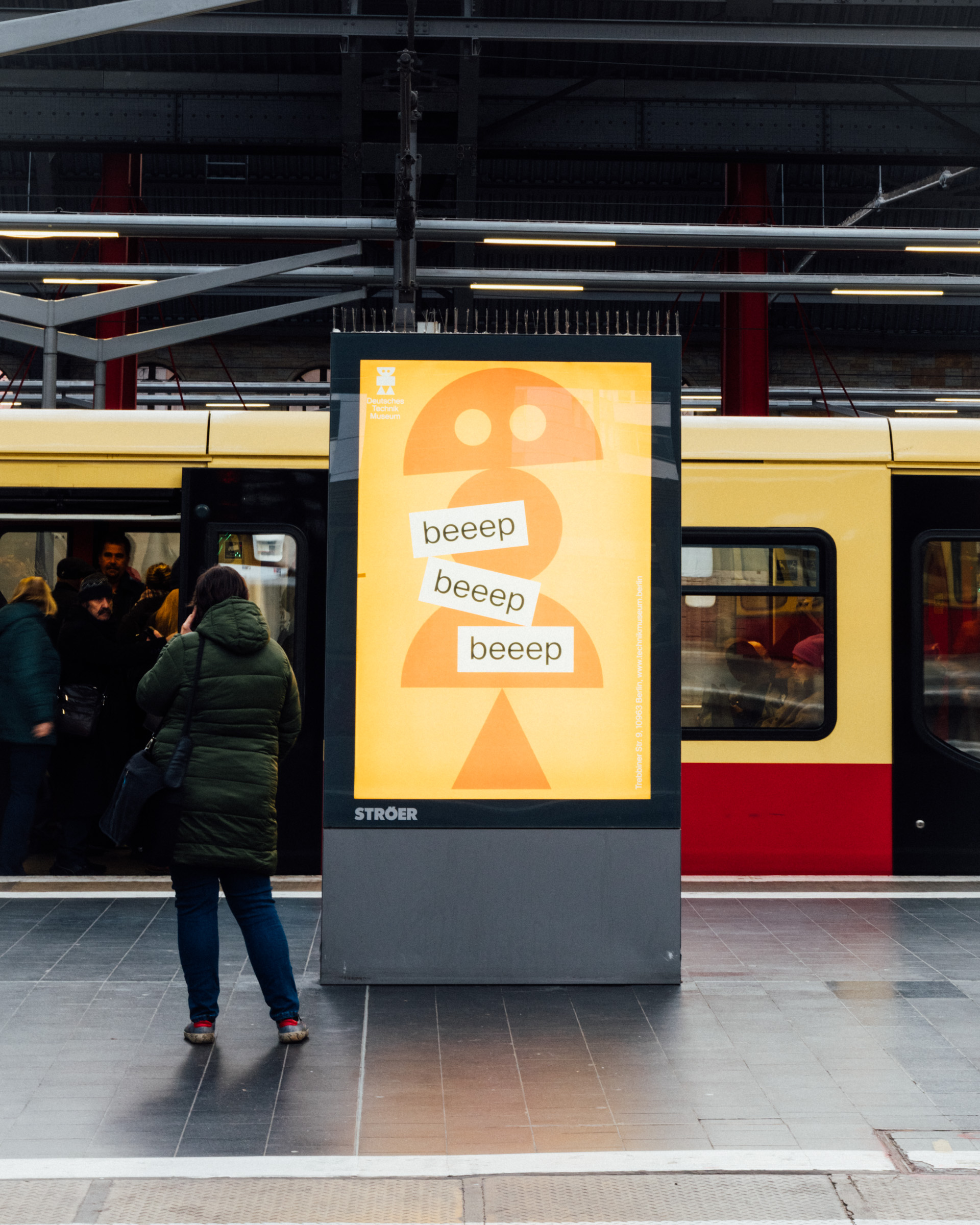 Ein Plakat, darauf ein oragenfarbener Roboter und die Worte "beep"