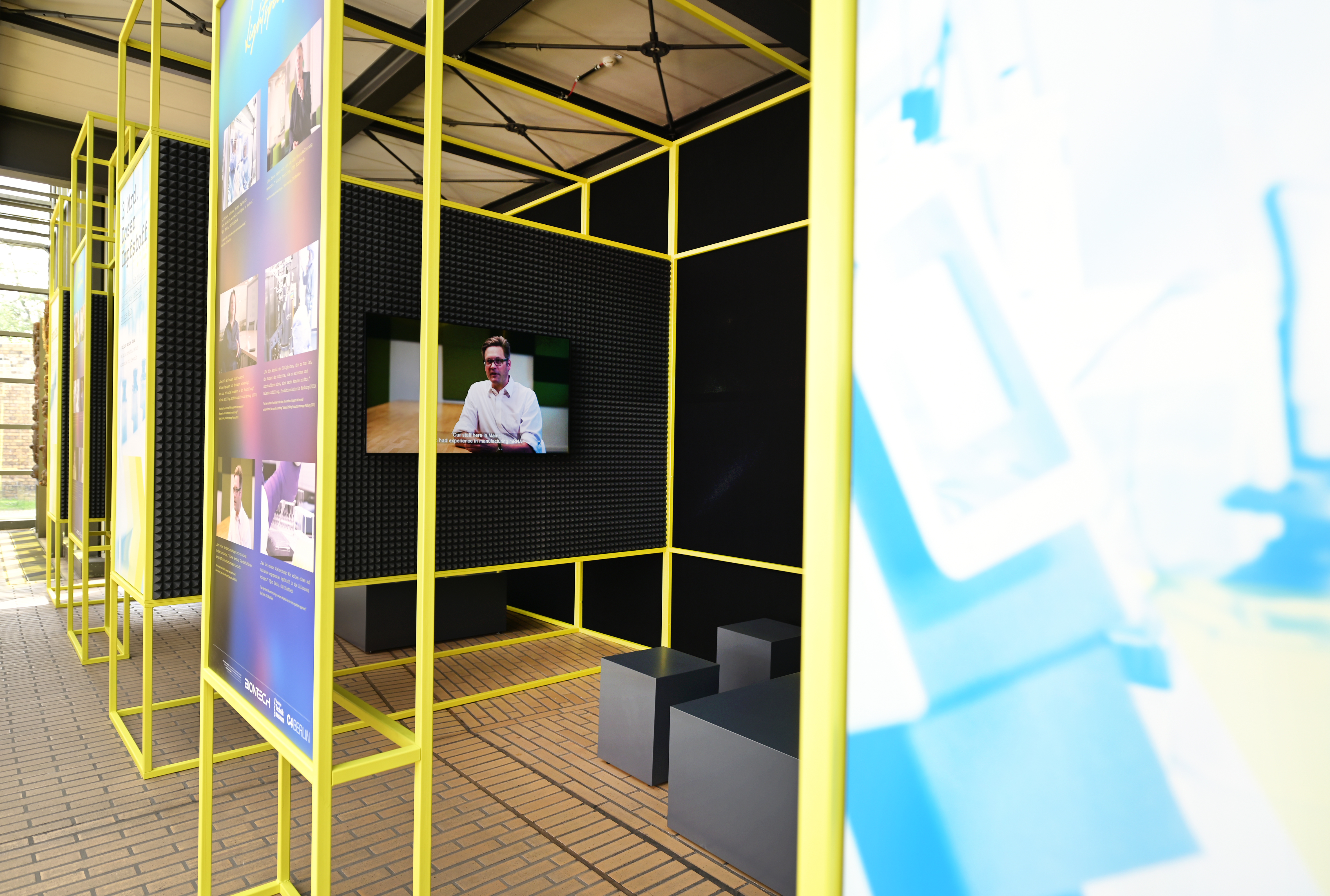 A view inside the booth, lined with black soundproofing material, where film clips related to the exhibition are shown.