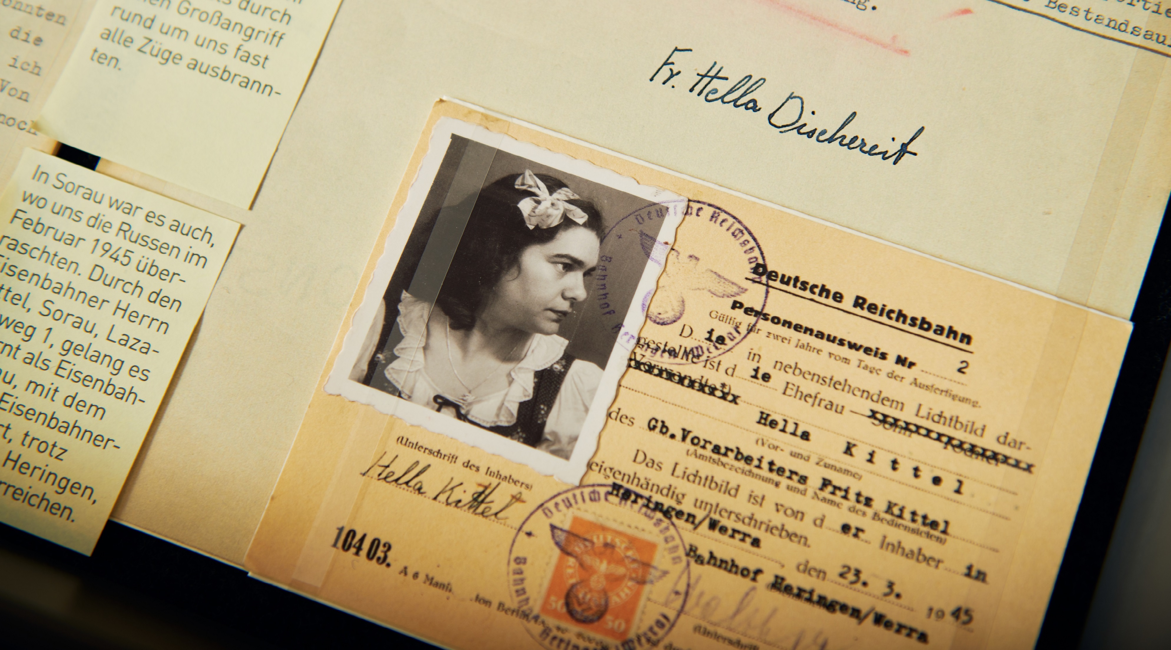 A Reichsbahn identity card bearing the photograph of a dark-haired woman, issued in the name of "Hella Kittel, wife of Fritz Kittel, a foreman," dated March 23, 1945.