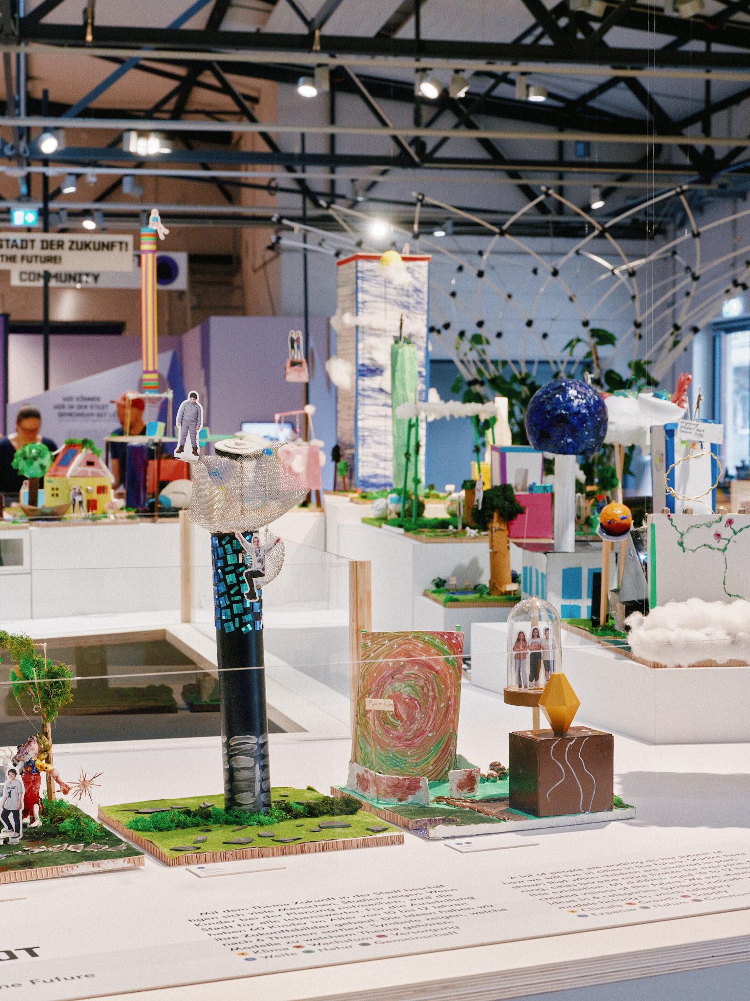 Surrounding the children’s imaginative models of their city of the future are themed areas such as “Climate” and “Growth.”