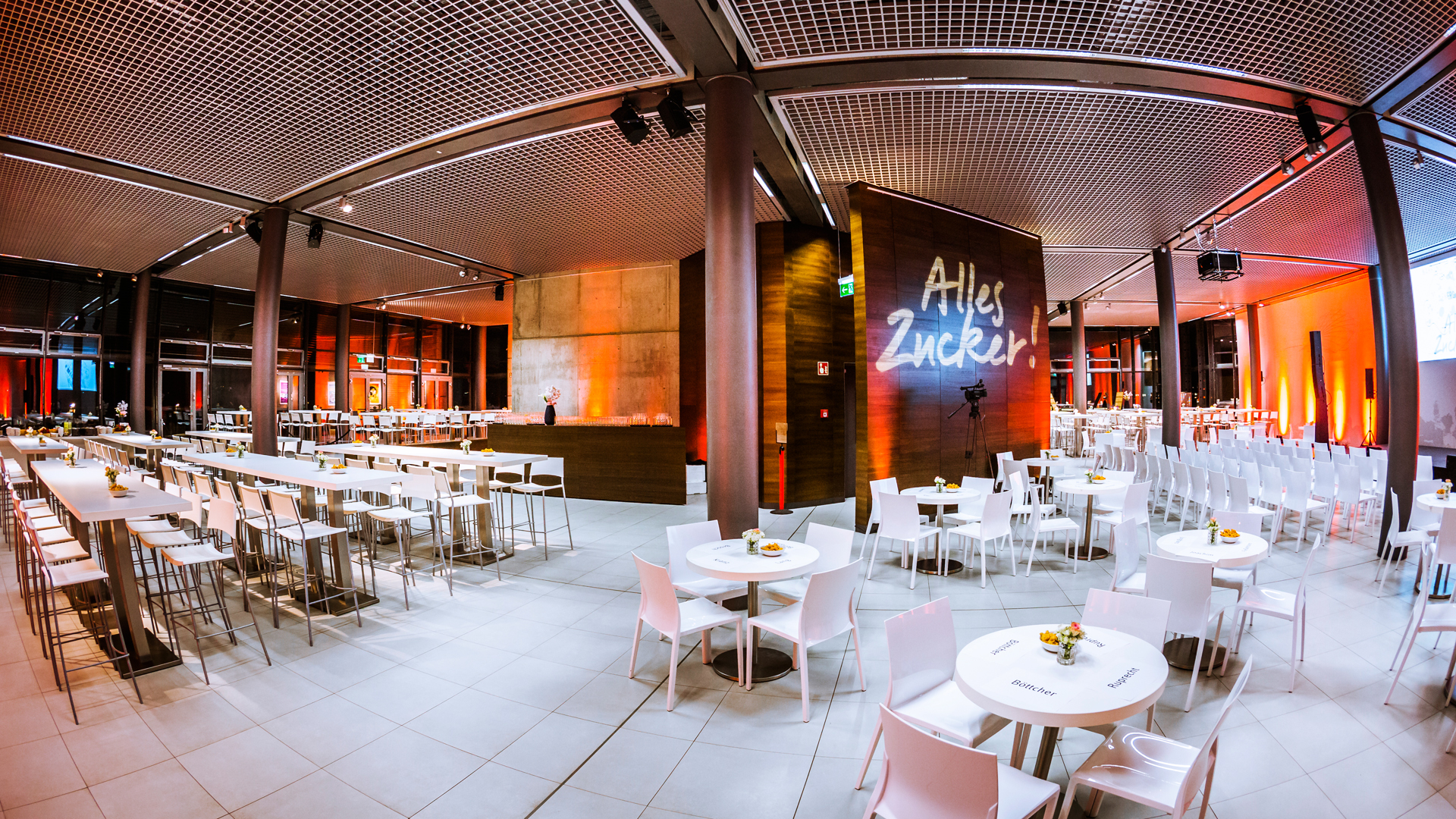 A view of festively set tables in a large room.