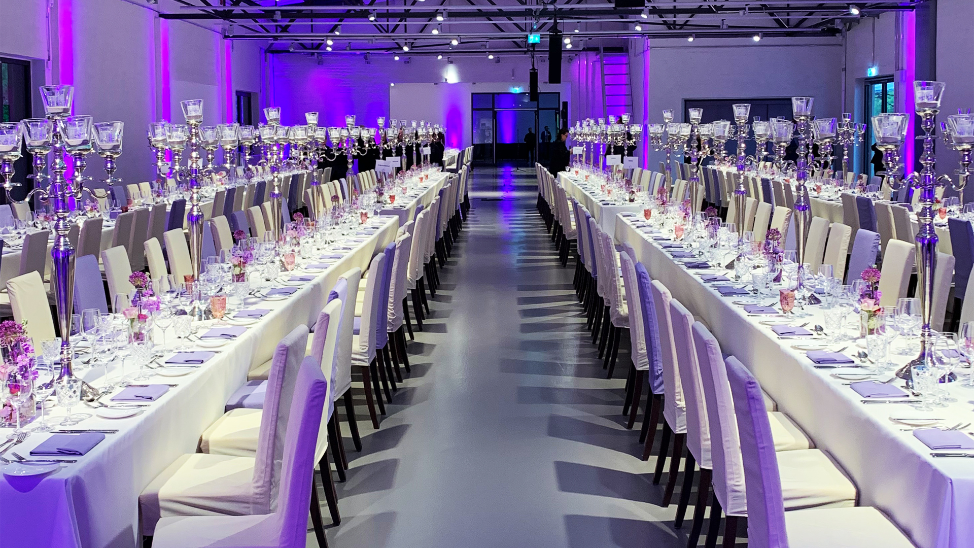 Long rows of tables, festively set.